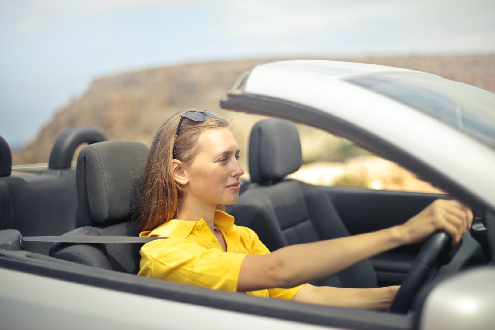 women driving convertible